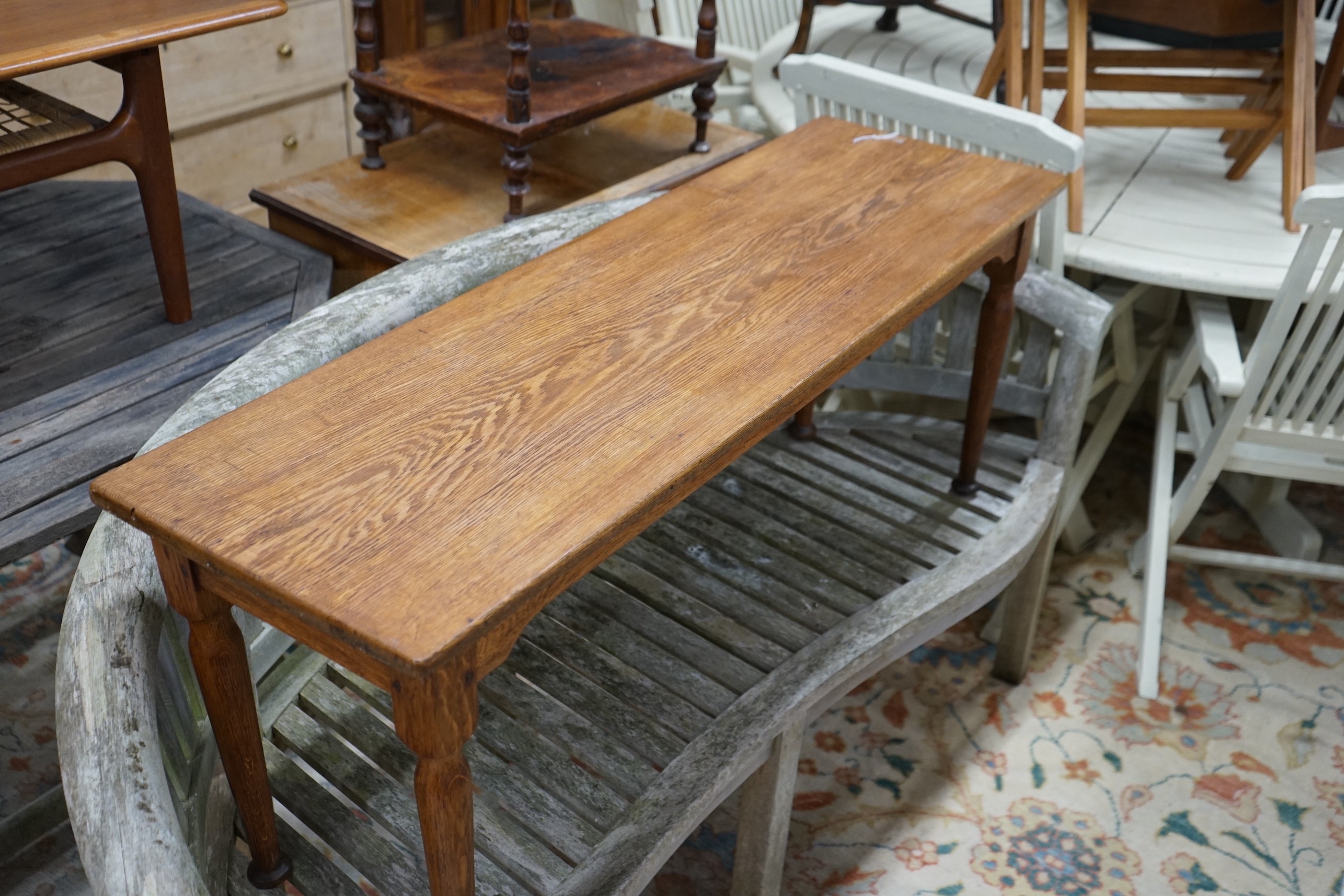 An Arts and Crafts rectangular oak low table / bench, length 122cm, depth 37cm, height 48cm